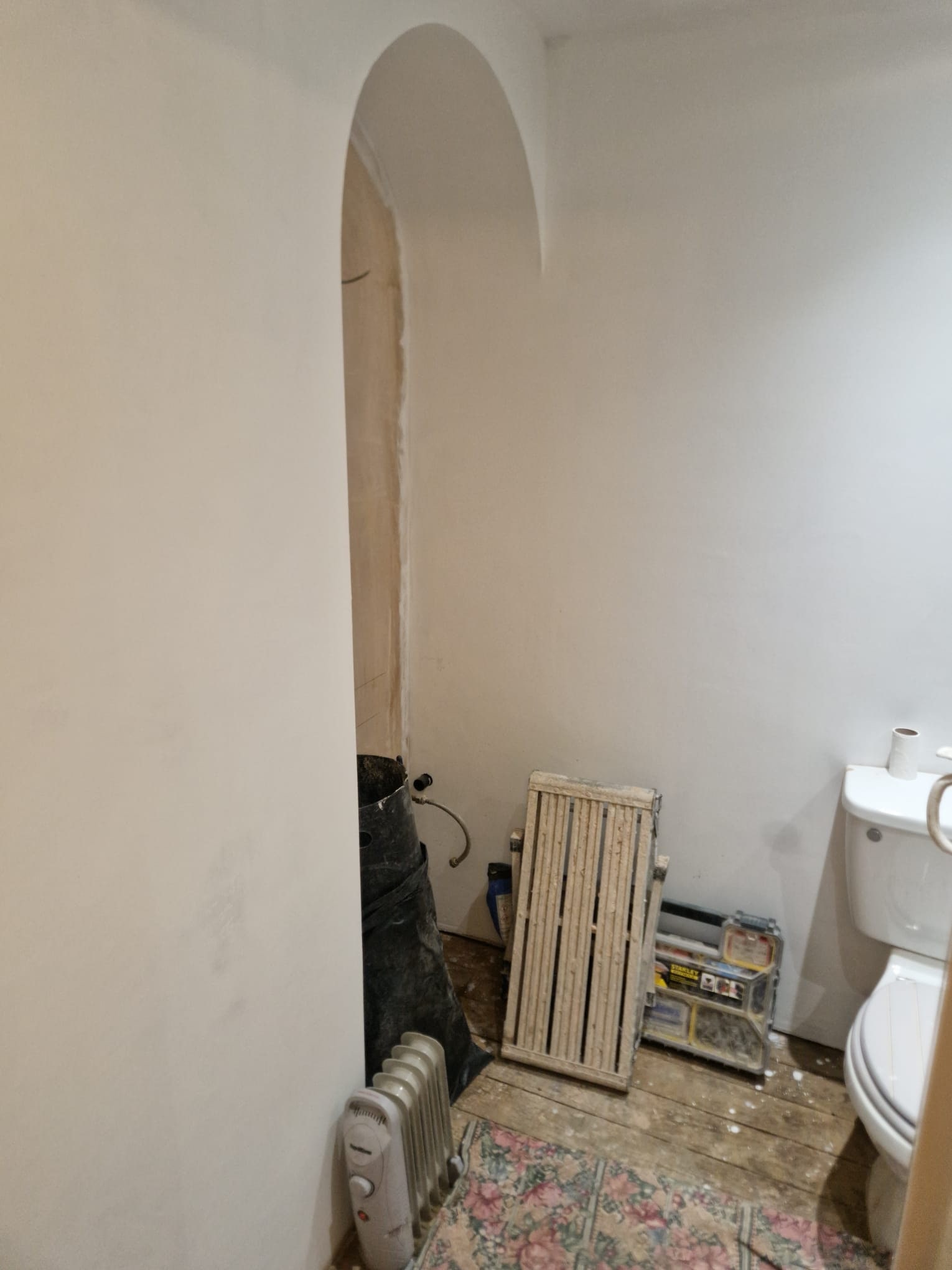 A Calm Greige Bathroom with Arched Vanity Before