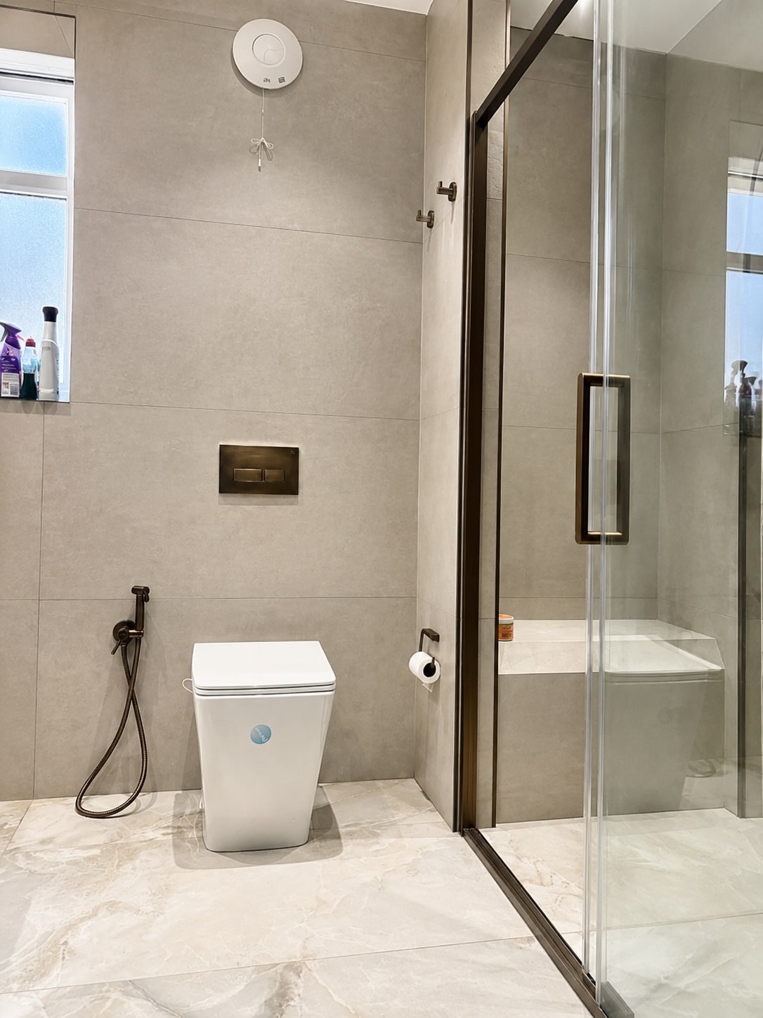 A Period Bathroom Reborn in Stone & Bronze After