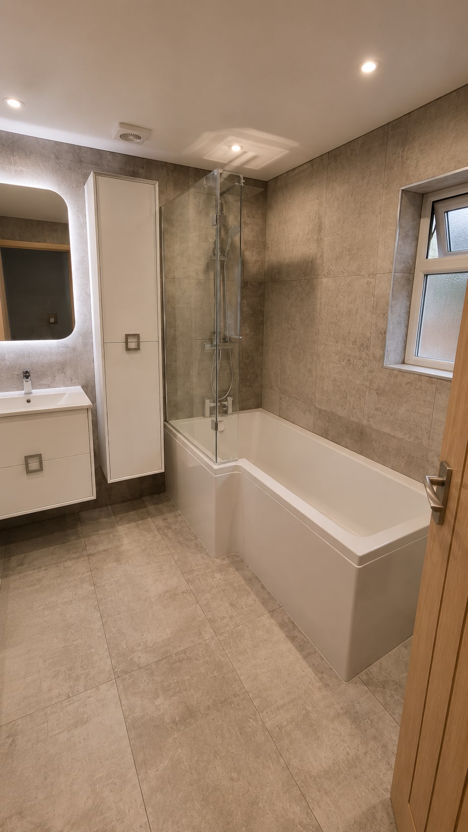 Warm Concrete & Oak Family Bathroom — Concrete-effect microcement, oak accents, shower-bath family bathroom by Bright Bathrooms, Greater Manchester