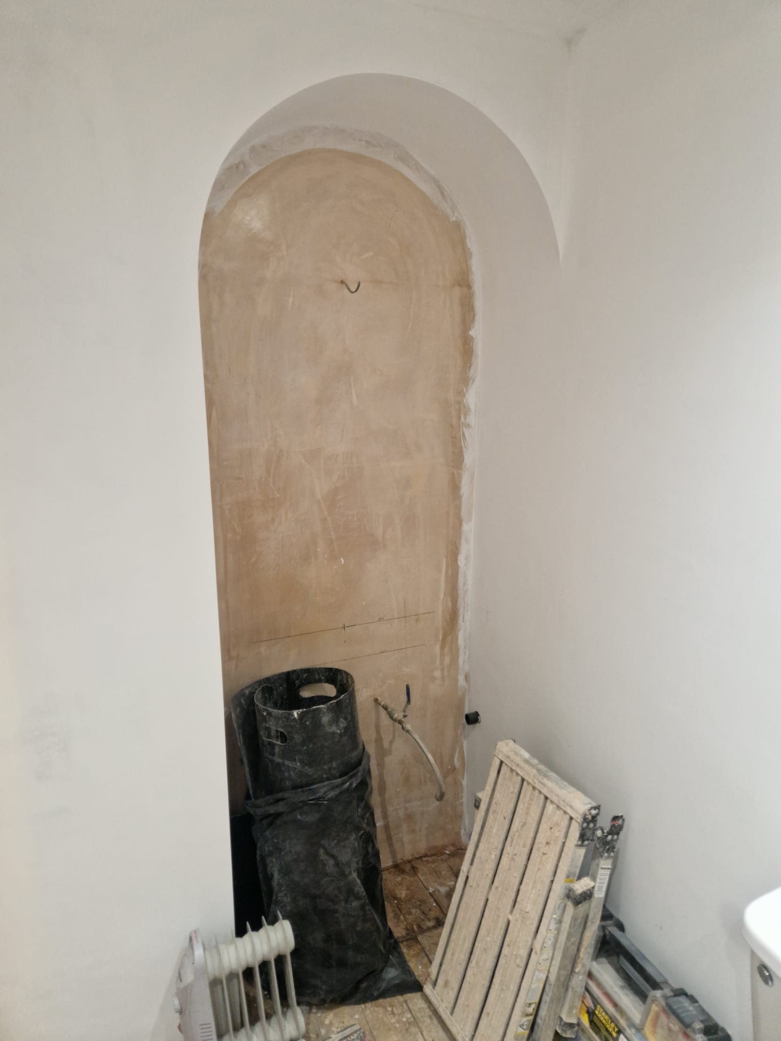 A Calm Greige Bathroom with Arched Vanity Before